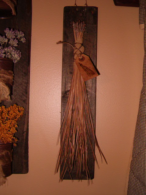 pine needle broom with wooden hanger