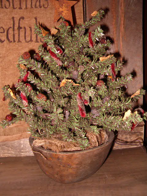Pre lit Christmas tree in gourd bowl